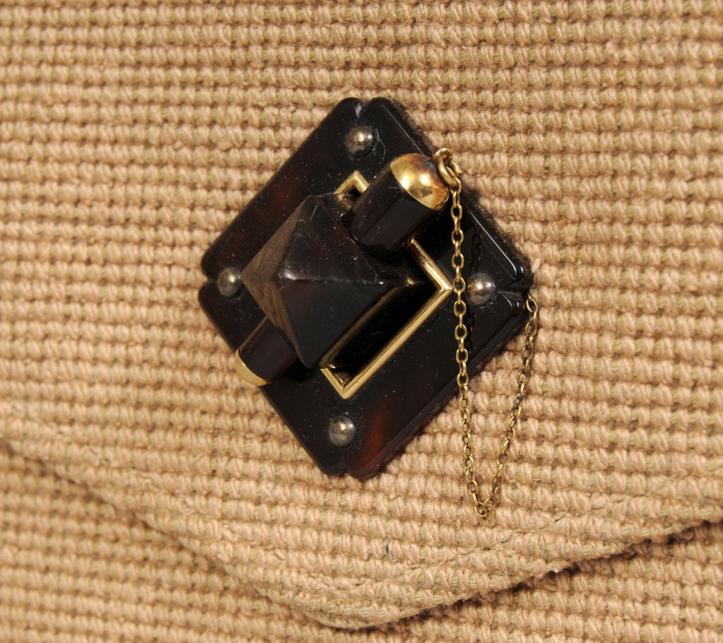 A rare 1930's clutch from Cartier, Paris is created from a natural woven linen fabric with a gorgeous and unique tortoise and gold clasp.<br />
<br />
The bag is lined with tan leather and has a large open pocket as well as a large zippered