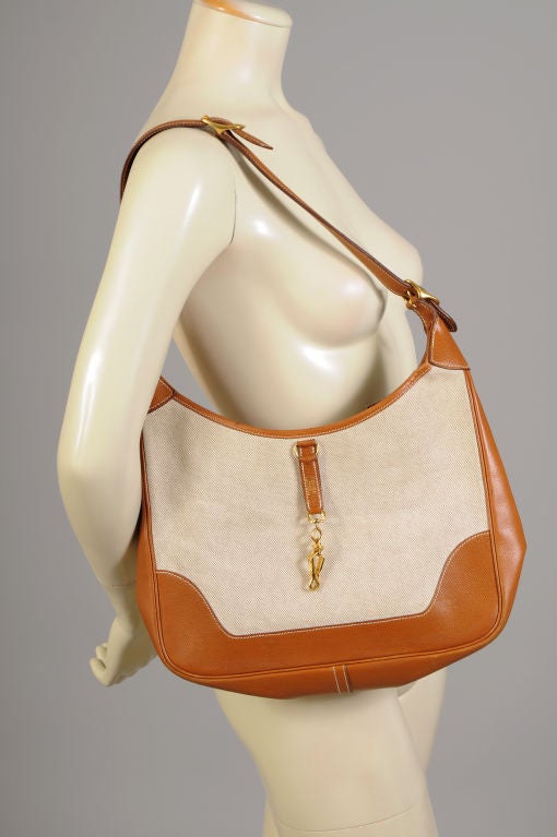 This Hermes Trim bag has rich brown leather trim and a natural canvas body.  It is in pristine condition inside and out.  There is a zippered compartment and an open pocket inside.  The bag comes with the original sleeper bag as well.<br />
<br