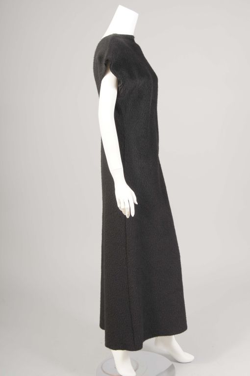 A sleek and modern dress from Commes des Garcons, this piece can be dressed up for evening or accessorized casually for  day wear.<br />
The fabric is quite plush, [no content tag remains], and adds to the elegance and versatility of the dress.  A