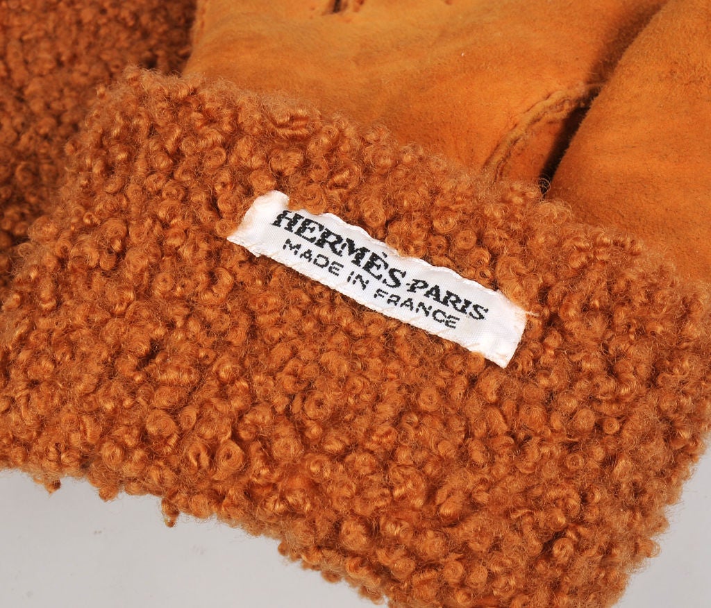 These bright orange suede shearling lined gloves from Hermes, Paris are so cheerful and toasty on a cold day.  They are in excellent condition and marked a size 7 1/2. if you are unsure of your glove size, it is usually the same as your shoe size.