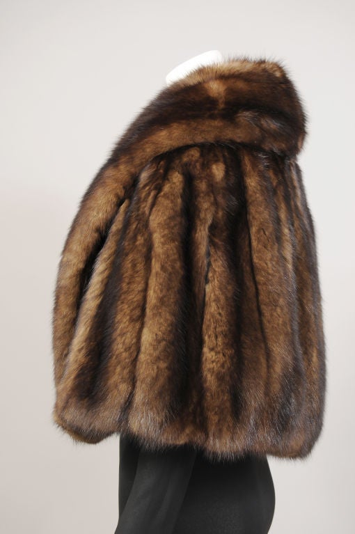 Deep chocolate brown Russian Sable is used for a luxurious and versatile cape from New York furrier Ben Kahn. This would be fabulous worn with a ballgown, or added to a coat or suit for extra warmth and glamour.  It is lined in a tone on tone floral