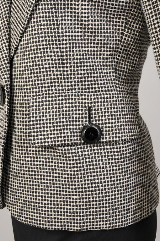 Perennially chic black and white wool is accented with bold black buttons for this great jacket from the Yves Saint Laurent Haute Couture collection.  <br />
The jacket has notched lapels and a one button closure. The pockets have flaps secured with