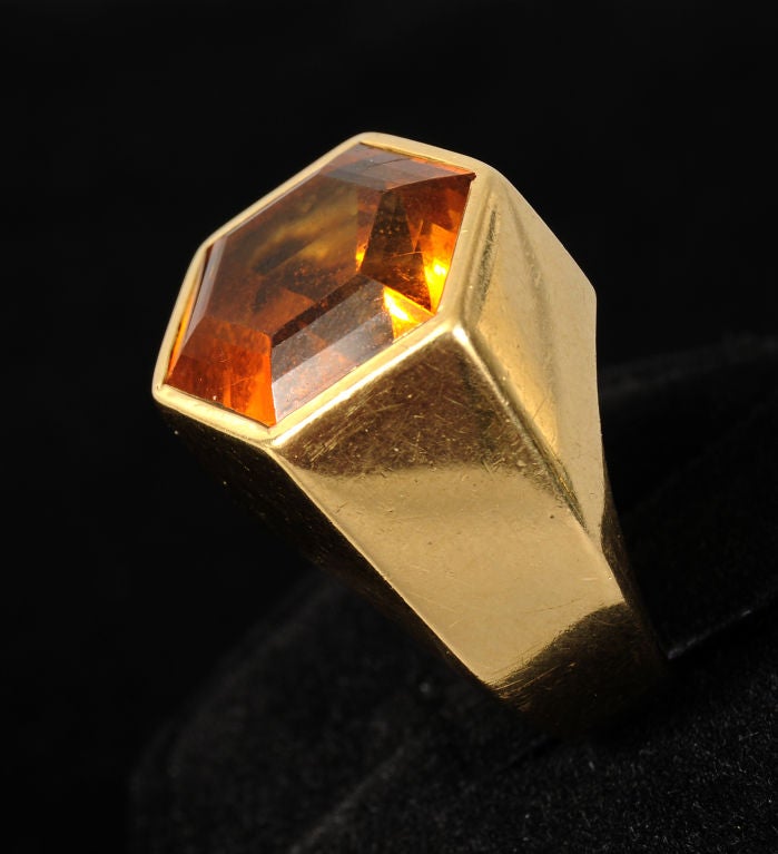 Paloma Picasso designed this citrine and gold ring for Tiffany & Co. in 1982. A very large citrine set in 18K gold makes a very bold statement. The clean lined design allows the beauty of the stone to shine. Richly faceted, it catches the light