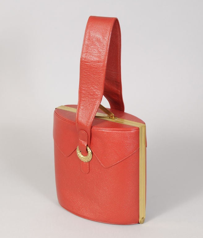 This is the most charming 1940's handbag from American manufacturer Evans. The exterior is cherry red leather with a sleek gold toned brass frame at the center of the bag. But the very best part is the inside!  This bag is so well thought out, there