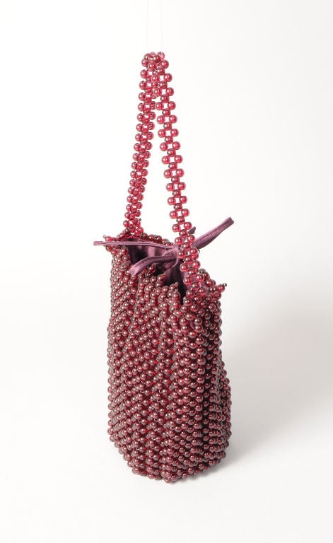 This is literally a jewel of a bag, made from hundreds of deep ruby red beads, the bag even has a beaded strap.  Bottega Veneta has done a very modern interpretation of an antique beaded bag.  The bag is lined in burgundy satin and closes with a