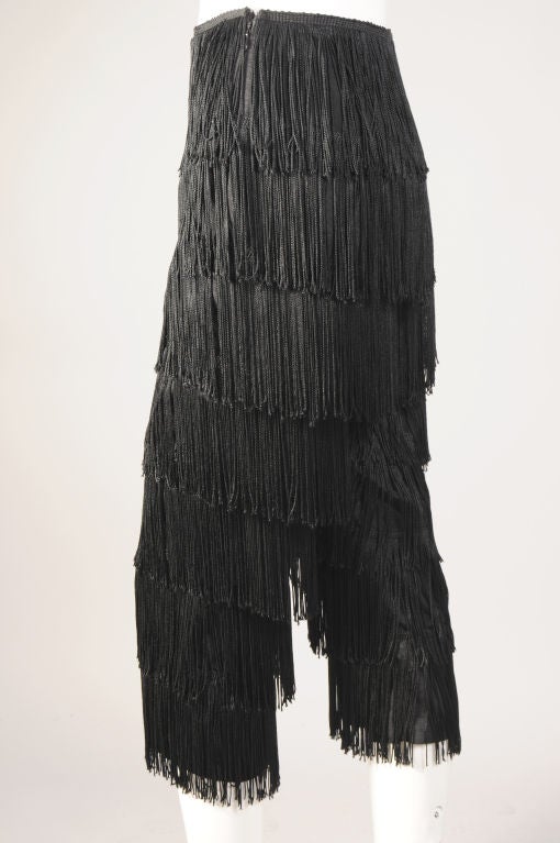 Shimmy, shimmy, shake!  What could be more fun than these Norma Kamali pants completely covered in lush black fringe?!<br />
The black faille pants have a flat waist line, side zipper and rows and rows of black fringe.  They are in excellent