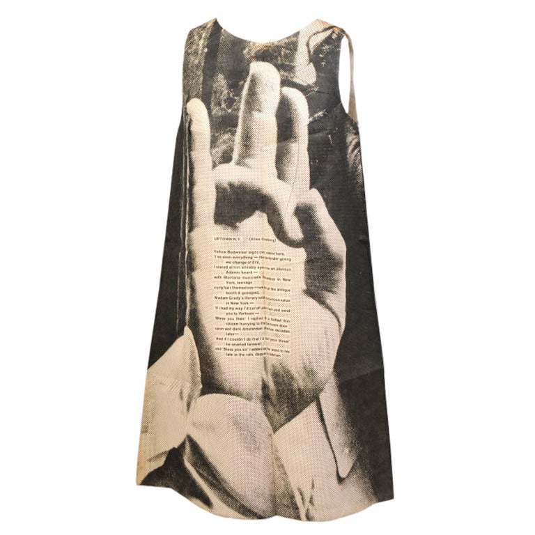 This is one of five paper dresses designed by Harry Gordon in the 1960's for the London Series, Poster Dress. It shows a hand with a poem written by Alan Ginsburg, entitled Uptown NY, on the palm. This dress is in pristine, unworn condition with the