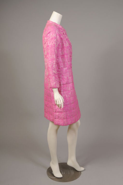 A Tina Leser Original, this shocking pink silk coat was made in India in the 1960's. The woven silk fabric is adorned with people astride elephants. The fabric is quilted as is the matching pink silk lining. This coat is so well made it would be