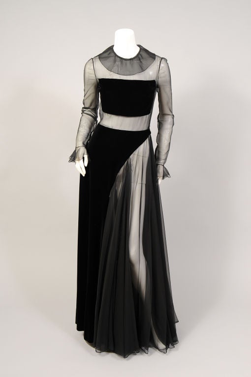 This Madame Gres dress from the late 1960' is just drop dead gorgeous! The bodice is made from a sheer black silk chiffon with a strategically placed black velvet panel. The long flowing skirt is half silk chiffon and half velvet. Wear it with black
