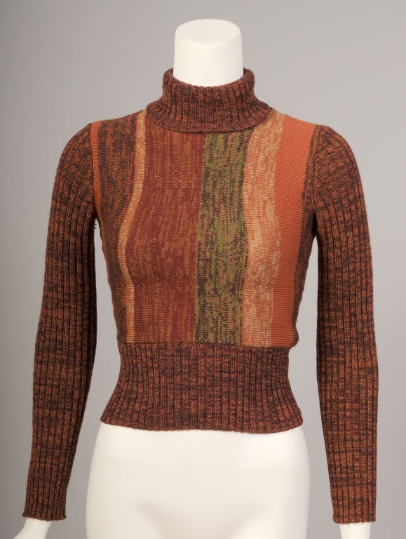 Autumnal shades of rust, brown, pumpkin, green and beige are knitted into this great Yves Saint Laurent Poor Boy sweater from the late 1960's. The turtleneck, sleeves and hem of the sweater are ribbed for a snug fit. The tight body of the sweater is