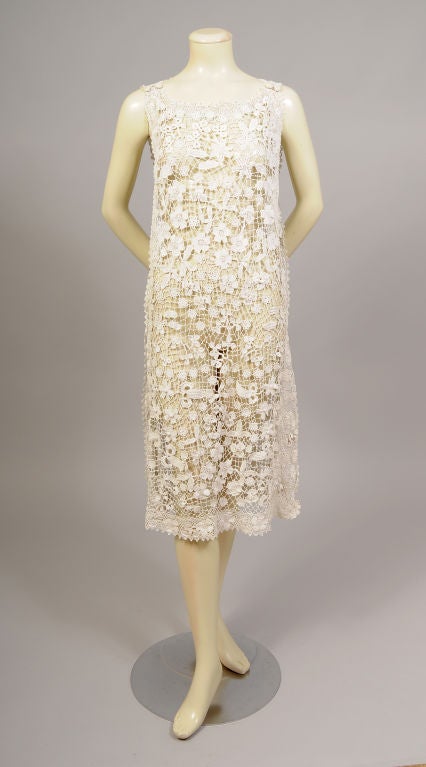 Exquisite hand made Irish lace in a raised three dimensional <br />
pattern of flowers and leaves is bordered by a more delicate Irish lace pattern of flowers creating a stunning 1920's dress. The sleeveless dress has a scoop neckline with