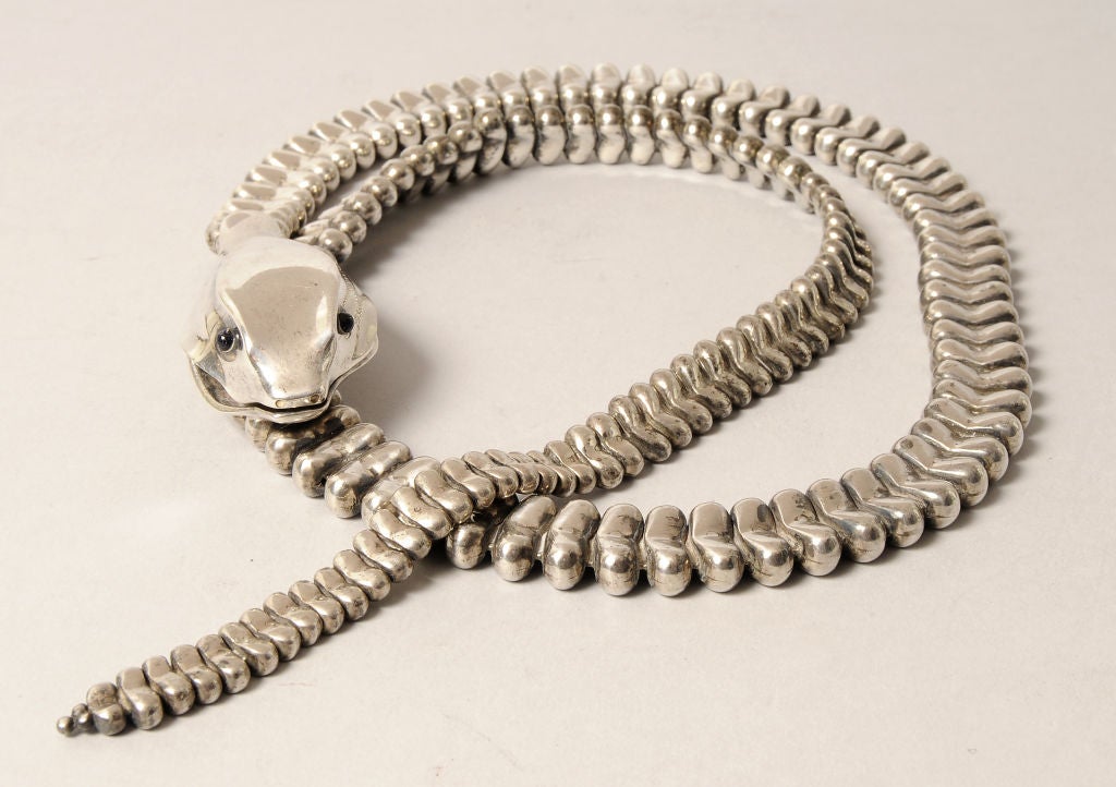 A striking sterling silver snake makes the perfect belt or necklace. The belt was designed by Elsa Peretti in the early 1970's to accessorize the designs of Halston. It was retailed by Tiffany & Co. and the head bears the appropriate hallmarks. <br