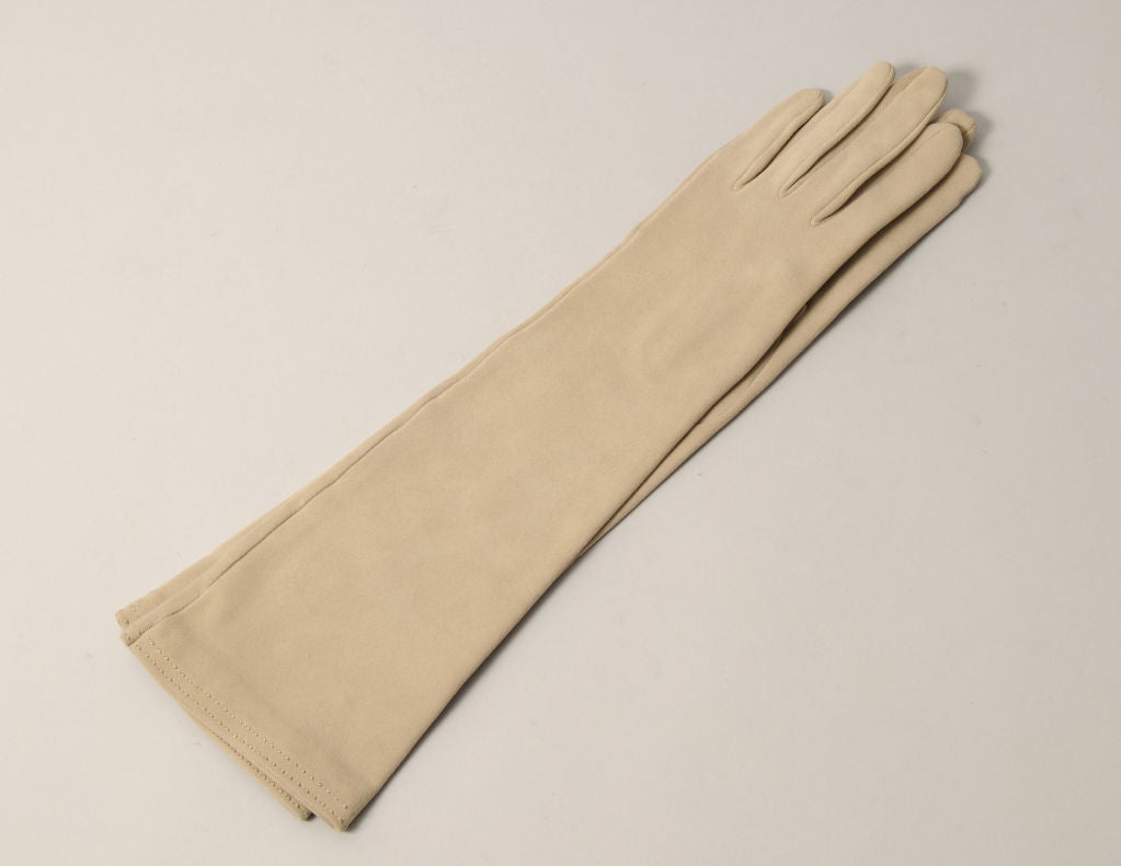 Pale beige suede gloves are hand made by Hermes, Paris. They are fully lined in silk and in excellent, unworn condition. They are marked a size 6 1/2. Glove sizes are usually the same as your shoe size.