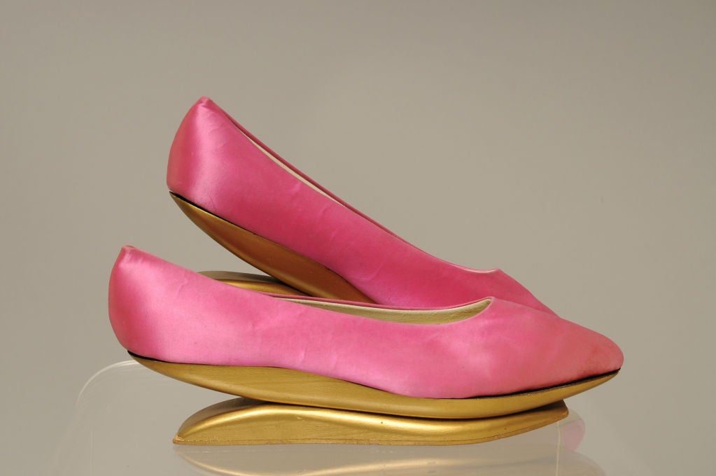 Beth Levine was the wife of Herbert Levine and the head designer for their stylish shoe company. These amazing Kabuki shoes have hot pink satin uppers and matte gold wooden two part soles. A visual treat, the shoes were first designed in the late