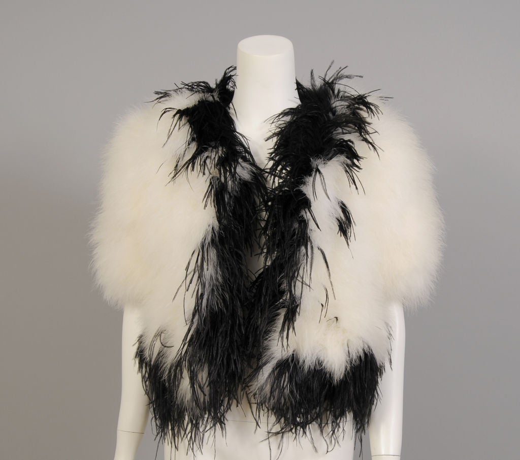 White swans down covers the body of this charming little feather chubby. The neckline, front opening and the hem are embellished with black marabou feathers. The jacket is fully lined and in excellent condition.<br />
<br />
Measurements;<br