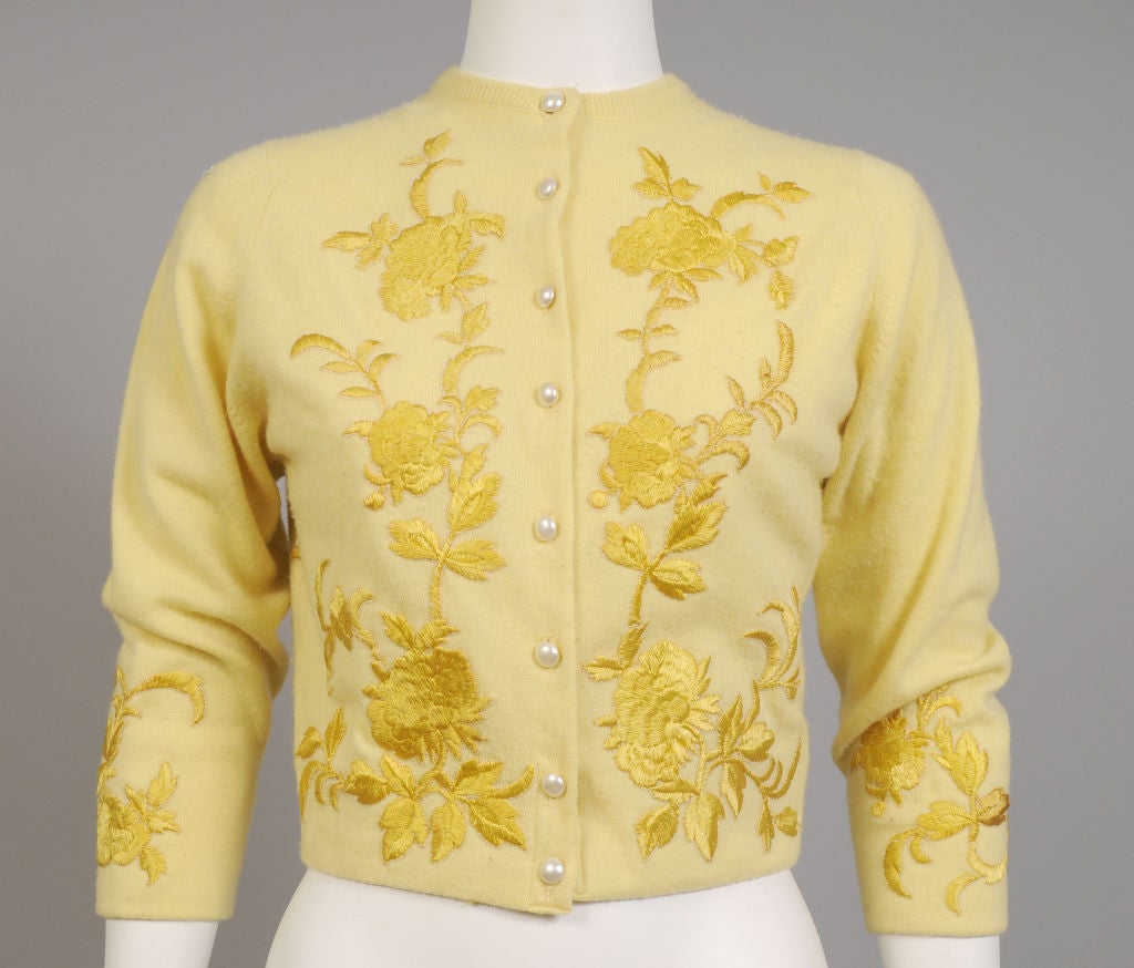 A cheerful yellow cashmere sweater is taken to another level of glamour by Helen Bond Carruthers of Versailles, Kentucky. The sweater is taken in on the sides, the hem is turned under and so are the cuffs, the buttons are replaced with pearls and
