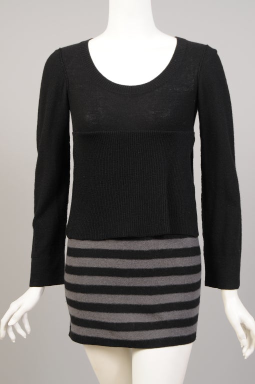 This sweater/dress from Sonia Rykiel looks like two pieces but it is actually just one. The black sweater is cut high on the sides to reveal a grey and black striped 