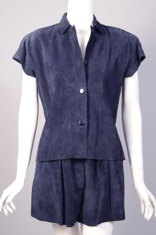 A Mario Valentino navy suede top and shorts set is a perfect summer outfit. The top has four navy buttons, cap sleeves and it is partially lined. The shorts are softly gathered with pockets on the hips and a zipper at the center front. Both pieces