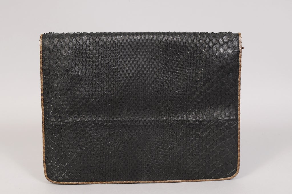 A fabulous clutch from the fabulous Maud Frizon is made from butter soft brown leather. Black snakeskin is used on the front flap and the back of the bag. This is trimmed with brown snakeskin and the whole bag is piped in brown snake. There is a