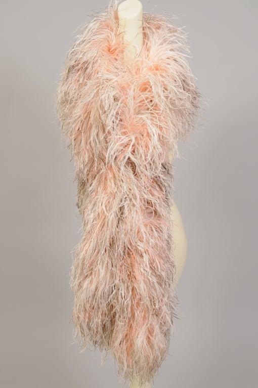 A combination of peach, brown and white ostrich feathers is used in this ultra feminine stole. Two bands of feathers are joined together on each side to create a piece that can be worn as a stole, a wrap or a boa. It is in excellent