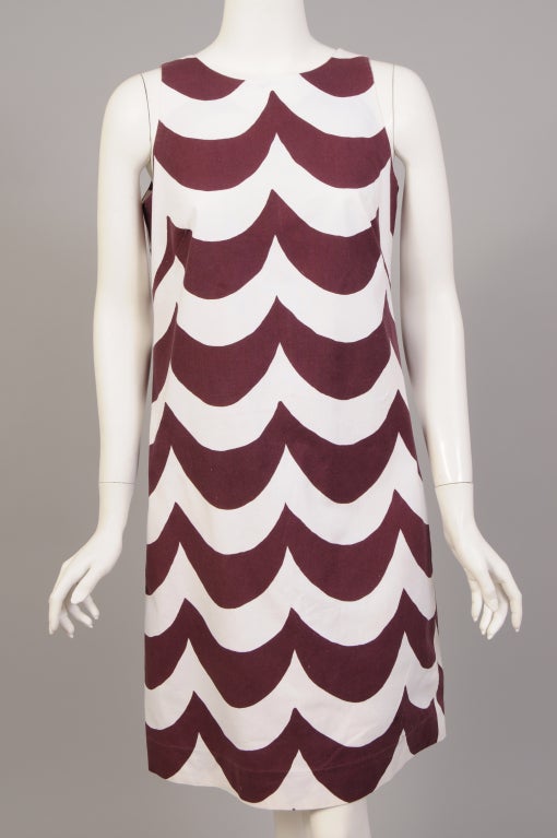 This graphic brown and white Laine dress is in the Tiira pattern designed by Annika Rimala. The sleeveless dress has a round neckline and a center back zipper. It is in excellent condition. It is dated 1965 and was retailed by Lord &