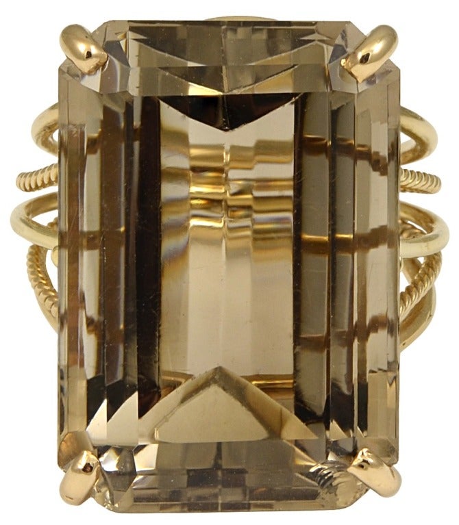This is a great cocktail ring.  It is a large smokey quartz and 14k yellow gold ring.  The quartz is estimated to be 32.19cts by way of measurement.