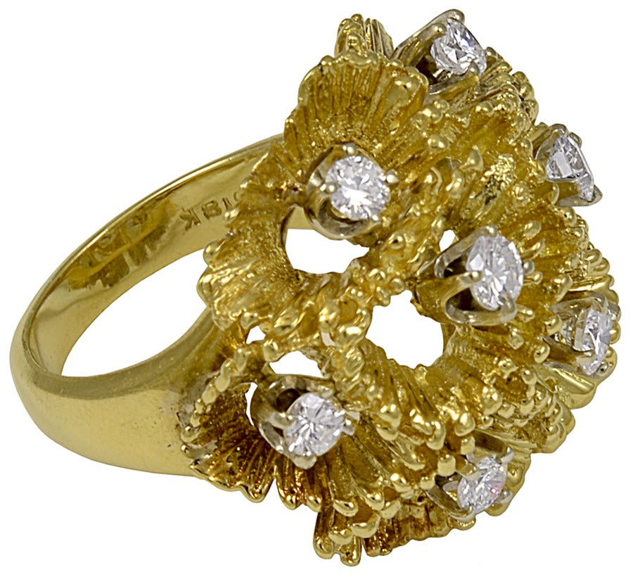 A uniquely designed pencil shaving textured gold and diamond ring.  The nine diamonds have a total estimated weight of 1.00cts and average G-H color, VS clarity.

Weight, color, and clarity are by judgement of a certified gemologist.