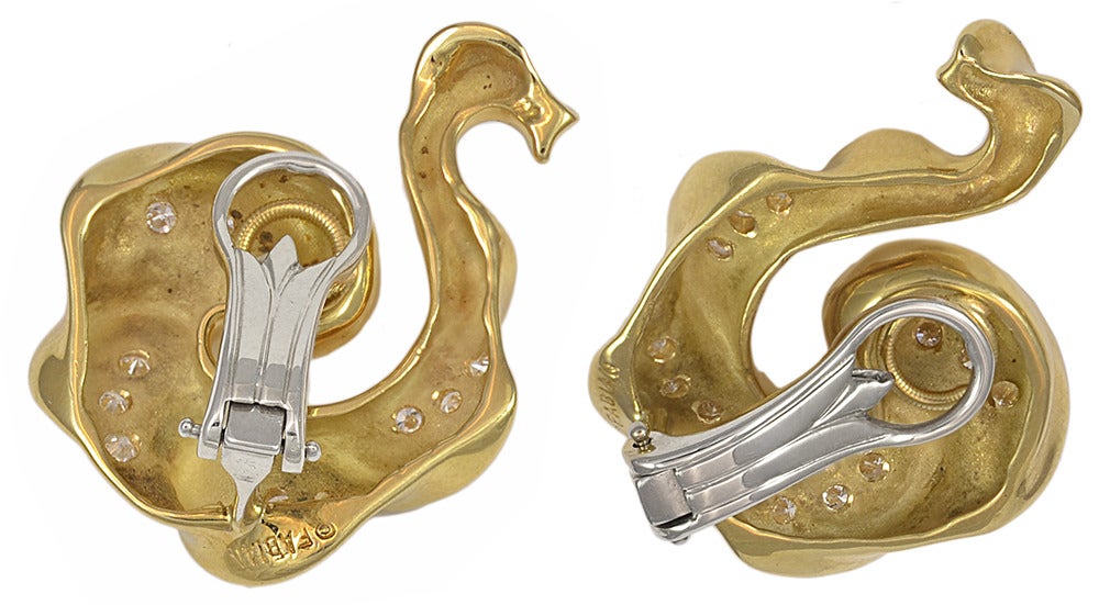 Diamond and 18k yellow gold swan shaped earrings.  The diamonds are round brilliant cuts with a total estimated weight of 1.00cts.  The earrings are clips.

Signed 