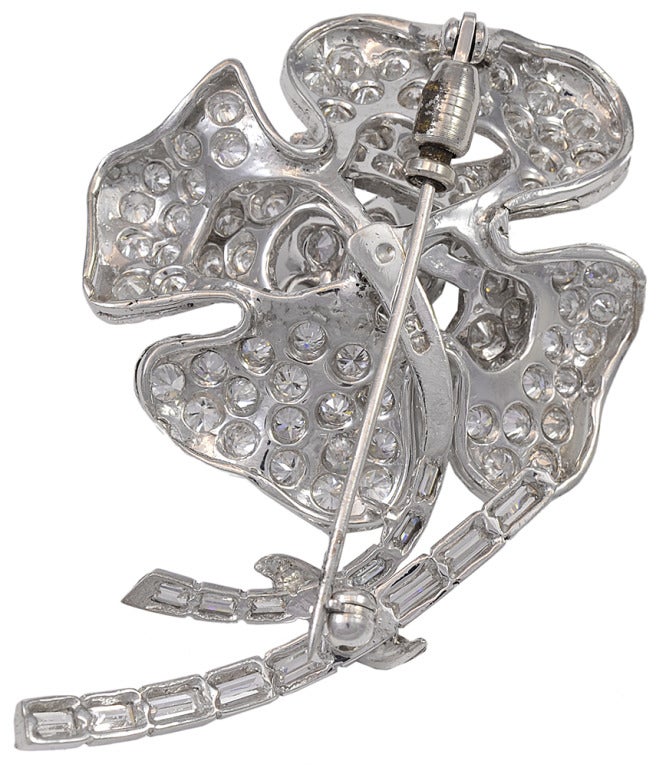 A great diamond flower brooch.  The diamond are baguette and round brilliant cuts, weighing an estimated 5.50cts total, set in platinum.
