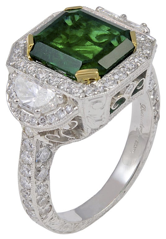 This is a beautiful emerald and diamond ring.  The emerald is 3.77cts, and has great color and life to it.  The mounting is handcrafted by Michael Beaudry, and has a total estimated diamond weight of 1.90cts, all set in platinum.