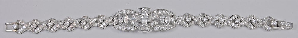 A beautiful Art Deco diamond and platinum bracelet.  The The diamonds in the bracelet are marquise, baguette, and round in shape, with a total estimated weight of 6.60cts.