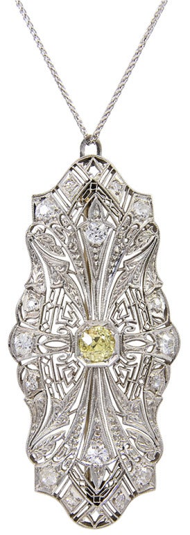 This is a beautiful Art Deco fancy yellow and white diamond pendant in platinum.  The center diamond is estimated to be 0.65cts, with 0.60cts in white diamonds set throughout the pendant.