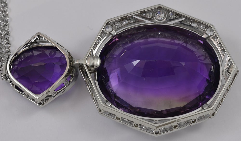 This is an absolutely stunning Art Deco amethyst and diamond pendant.  The two amethyst match in a rich deep purple color, and have a combined estimated total weight of 61.50cts.  The diamond frame is made up of old European cut, and single cut