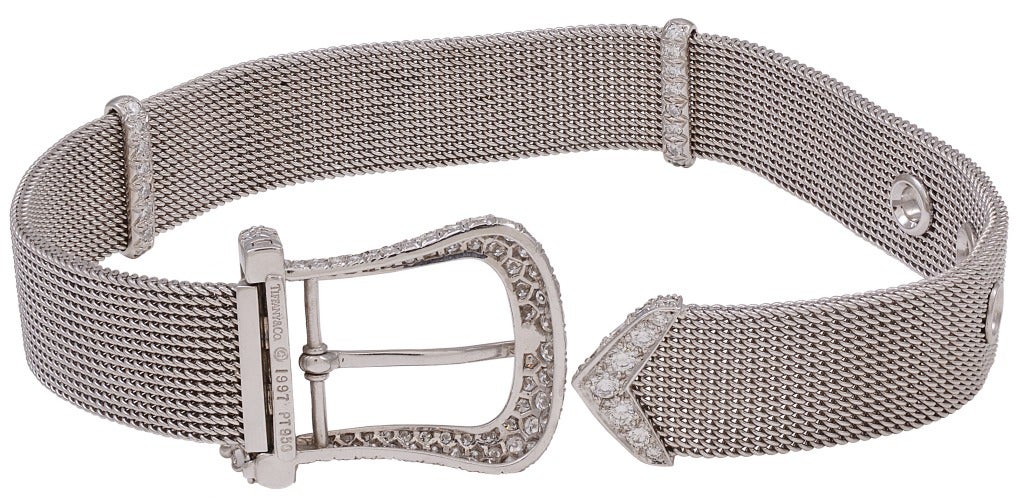 A smooth as silk Tiffany & Co. diamond and platinum belt buckle style bracelet.  The bracelet is set with all round brilliant diamonds with an estimated total weight of 3.00cts.  Signed 