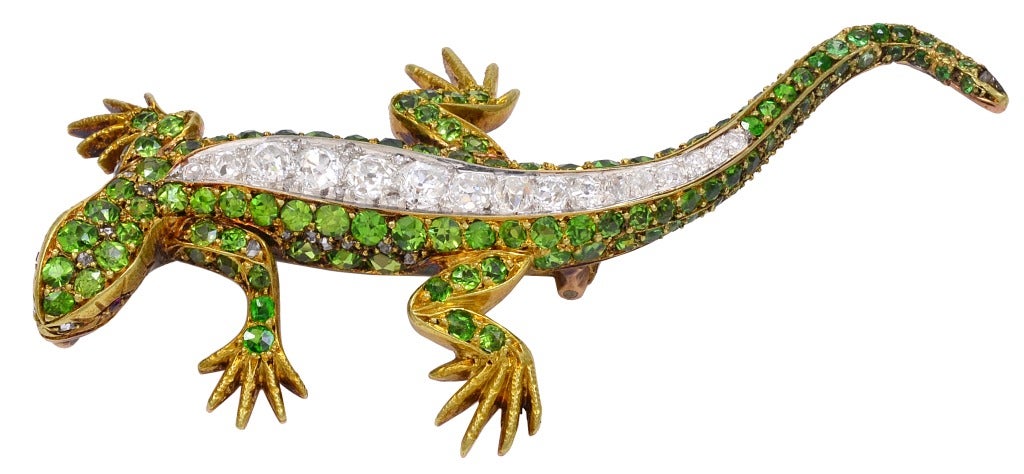 A stunning demantoid garnet and diamond 18k yellow gold lizard brooch.  There is approximately .63cts total in diamonds.

While garnets have been known since ancient times, the demantoid variety was not discovered until 1868 in Russia's western