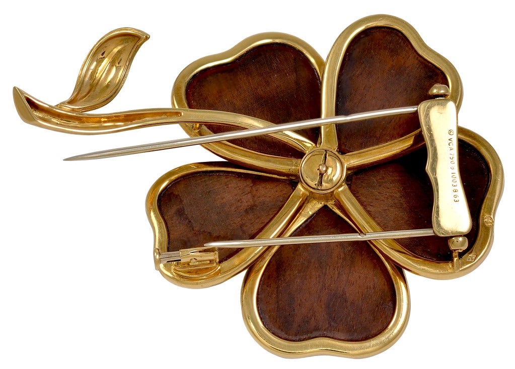 A brooch and earring set that is truly a work of art.  In 1972, Van Cleef & Arpels created a clematis brooch and earrings out of amourette wood.  They are set in 18k yellow gold and the center of the flowers are set with diamonds.  Approximately