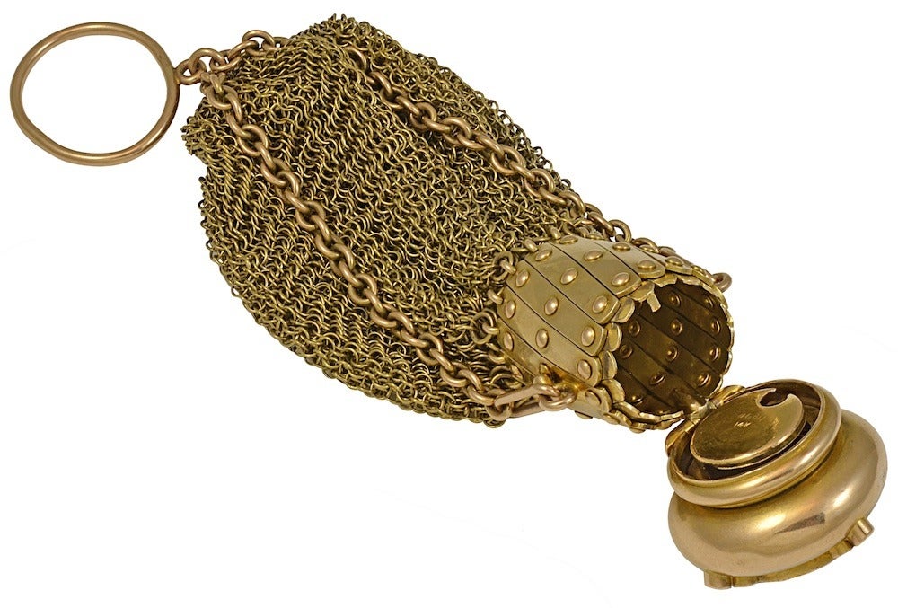 A beautiful Victorian Era garnet and diamond 14k yellow gold coin purse.  The top simply turns to lock and open, and the cylinder expands.  This piece displays excellent craftsmanship.