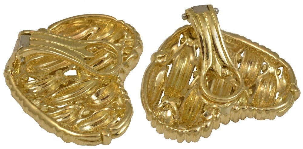 Tiffany & Co.  18kt yellow gold woven heart design clip earrings.  A design that can be worn day and night, from the Tiffany Signature Series.

Signed 