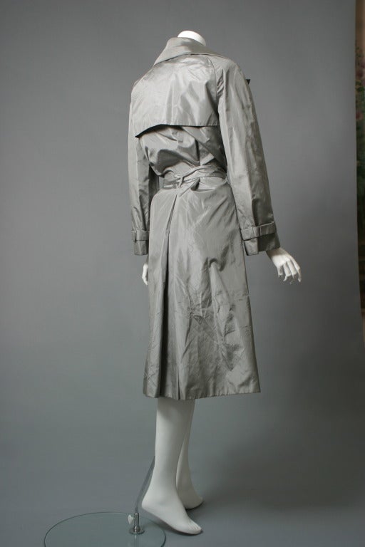 Guy Laroche, haute couture, 

Beautiful mouse grey silk taffeta evening trench, wide cut collar, ties around the waist, raglan sleeves, padded shoulders, studs fastening ,diagonal pockets, the taffeta is doubled up and beautifully worked..
Studio