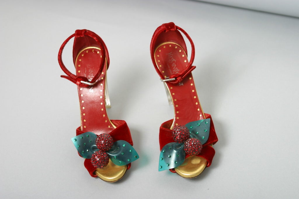 Yves Saint Laurent, by TOM FORD , Paris, Fall 2003

Sublime Collector very rare pair of red velvet sandals with clipping Swarovski red cherry on green plastic leaf like bow, incredible transparent square heel filled with diamond like rhinestones,