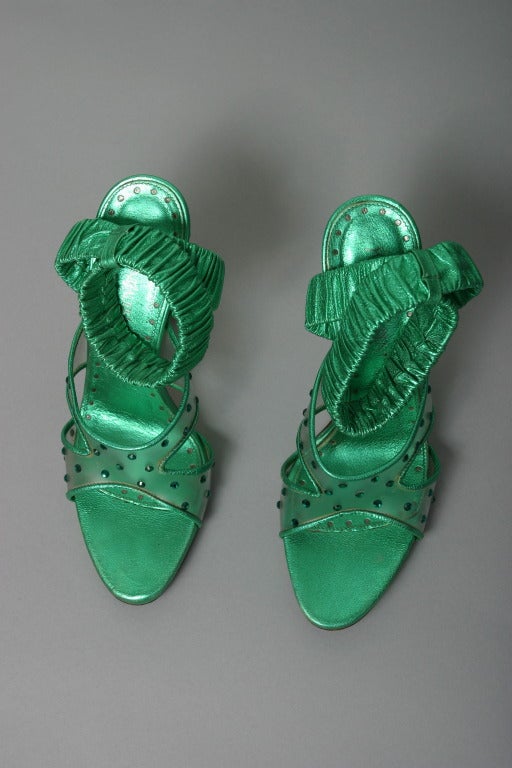 Yves Saint Laurent, by TOM FORD , Paris, fall 2003

Iconic sandals, present during all the show in different colors, made of soft pleated emerald lame calfskin leather, clear plastic heel and front, dotted with emerald Swarovski crystals? 
Inner