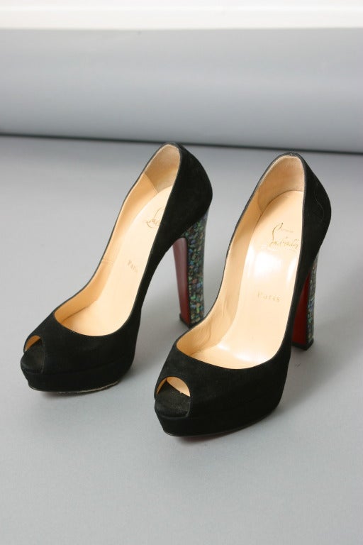 Christian Louboutin , Paris, circa 2012
Glamorous black suede peep toe pumps with Nacre fantasy high heel 
Inner sole of nude leather stamped gold.
Classic red Louboutin soles.

Marked size : 37 
Approx. US Size : 7 
Heel : 12 cm
Made in