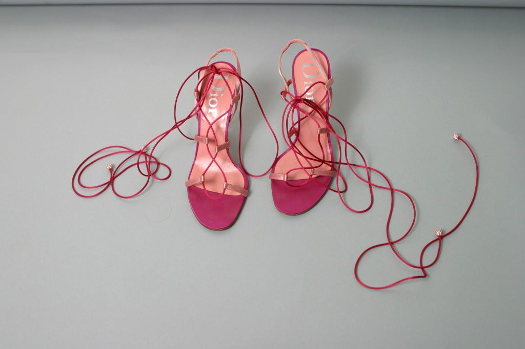 Christian DIOR, by John GALLIANO , Paris, circa 2003
Soft and hot pink  laced up sandals.
Inner sole of pink leather stamped silver.
Classic nude Dior soles.

Marked size : 37 1/2
Approx. US Size : 7 1/2
Heel : 10 cm
Made in Italy.

Fair