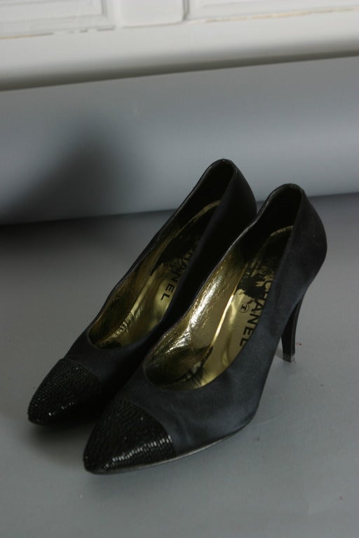 CHANEL, by Karl Lagerfeld , Paris, circa fall 1985

Iconic CHANEL black satin evening pumps, the toe embroidered with black tubular beads.
Inner sole of gold leather stamped black.
Classic black Chanel soles.
Marked size : 8
Approx. US Size :