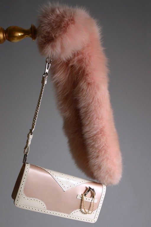 A John Galliano for Christian DIOR, spring- summer 2004, ultra glamorous, feminine and sophisticated pink silk satin, white pierced leather and pink dyed fox shoulder handbag.
Stamped DIOR on the silver palladium hardware.
A large D initial on a