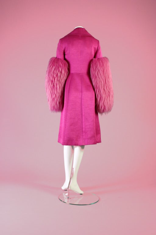 Christian DIOR, by John GALLIANO, autumn- winter 2007.

Divine shocking pink shimmering jersey evening coat .Long sleeves dramatically adorned three quarter way with shaded matching fox .Double breasted, curved collar, diagonally shaped seams