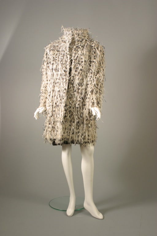 Jean Louis Scherrer, haute couture, un- labelled, circa 1985

Absolutely couture! this superb plastic and wool fancy tweed like cloth by bucol, the beautiful weaving embroidered by lemarié with black and white and white ostrich feathers, entirely