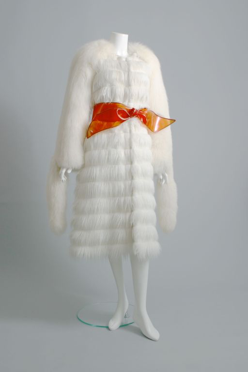Yves Saint Laurent, by Tom Ford, circa 2004

Very amusing winter coat, full of fantasy, the body of horizontal  striped polyester fur, zipped like a cosy anorak, the sleeves being of the most beautiful white fox fur, complete with tails, it comes