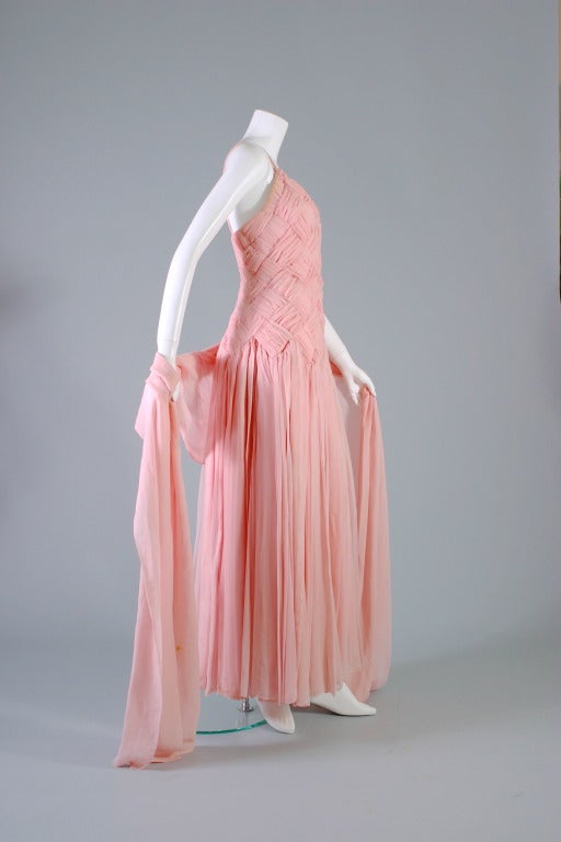 Guy Laroche, haute couture, circa summer 1984,

Evanescent ball gown... Meters upon meters of of silk chiffon rolled by hand.
The pink satin bodice masterly and entirely draped with an interlaced weaving effect of chiffon forming criss cross