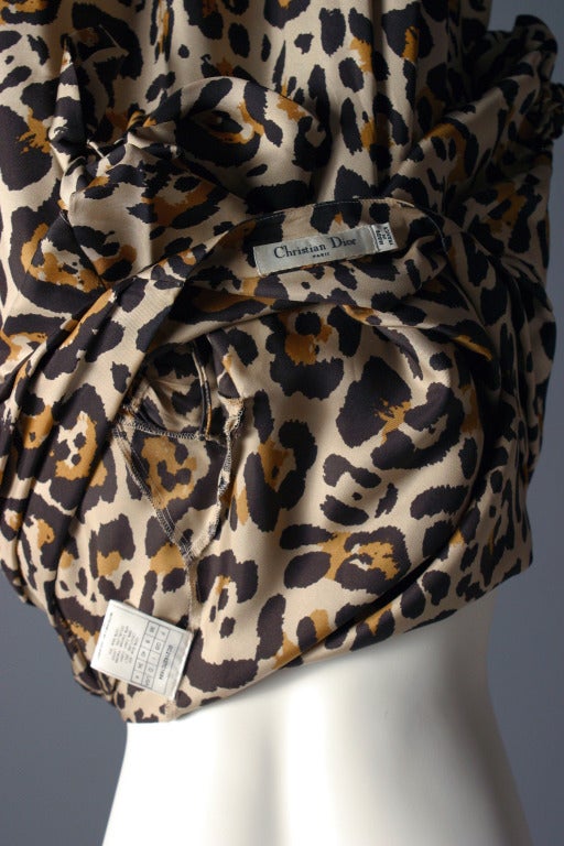 A Christian DIOR, ready to wear, by John Galliano

Leopard print silk dress, labelled  ''Christian Dior Paris ''deep V neck draped from the shoulders to the waistband, short fancy sleeves cut up with matching ties, ample skirt from the pleated